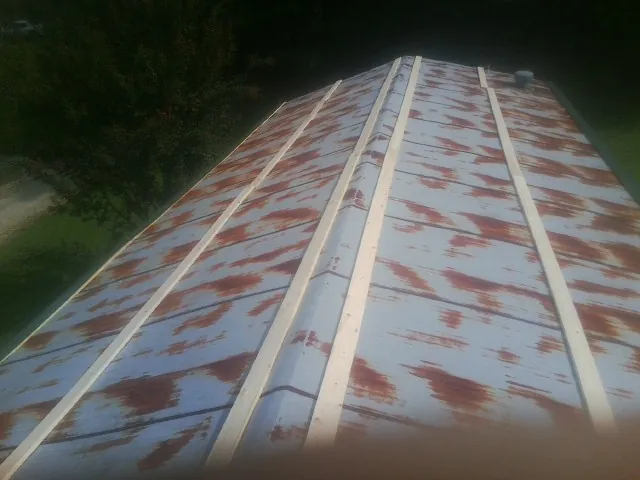 Rusted metal roof panels with new wood purlins before replacement — Storm Damage Roof Repair in Alabaster by Roofing Brothers